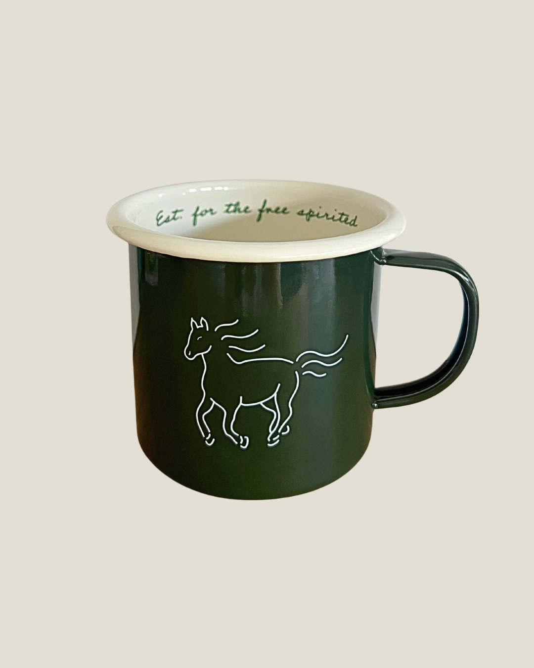 Green mug with a white horse design and text on a beige background